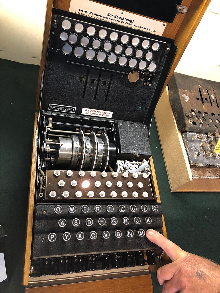 Enigma machine https://commons.wikimedia.org/wiki/File:Enigma_Machine_A16672_open,_letter_L_pressed.agr.jpg CC BY-SA 4.0.
