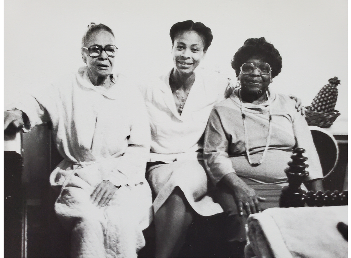 Fig 3. Black and white image of three woman sitting on a sofa.