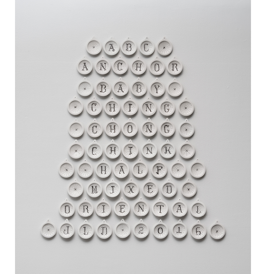 Image of white shower drangs. Each sculpture represents a letter that spells out xenophobic epithets.