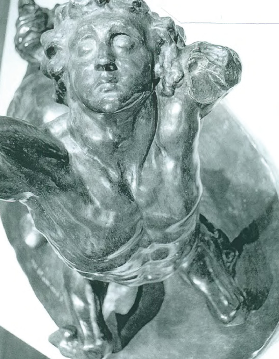 A detail of an elevated view of the sculpture; the centaur's face is upturned and his eyes open.