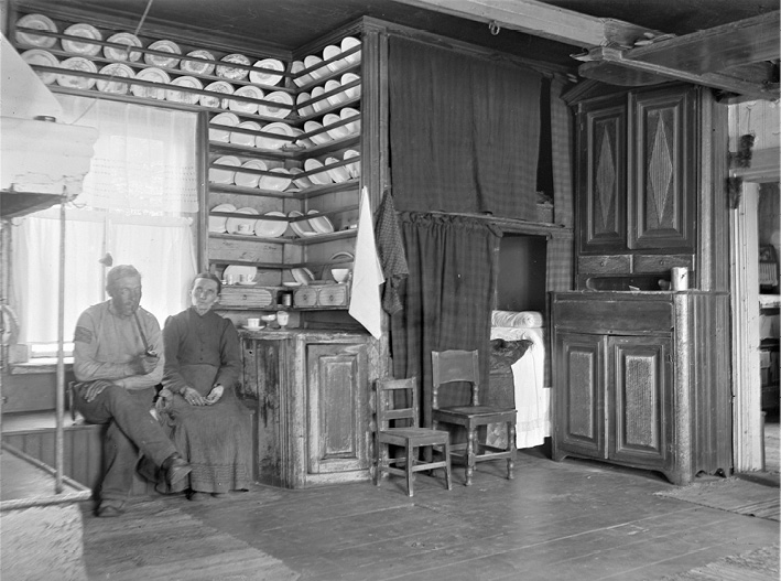 A man and woman sitting in a farmhouse in Oravais in Ostrobothnia (1916). Photograph by Valter W. Forsblom.
