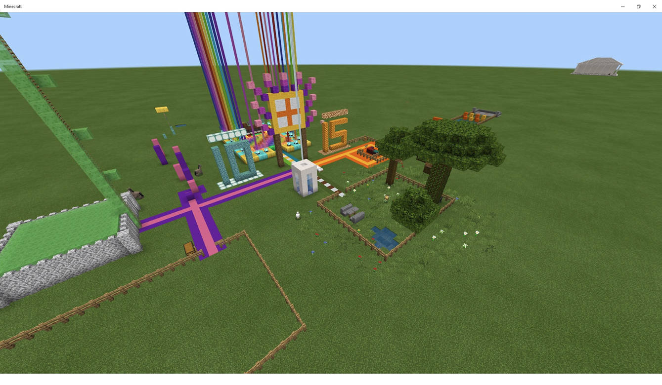Screenshot from Minecraft of a joint birthday party, showing grass and trees, the ages 10 and 15, with a flag in between