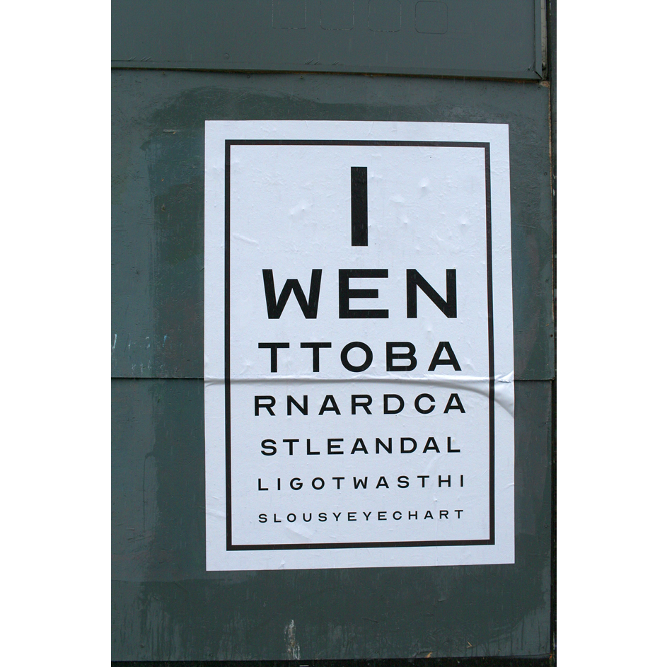 Photo of a printed eye chart, with rows of letters in diminishing size, spelling out the message 'I went to Barnard Castle and all I got was this lousy eyechart'