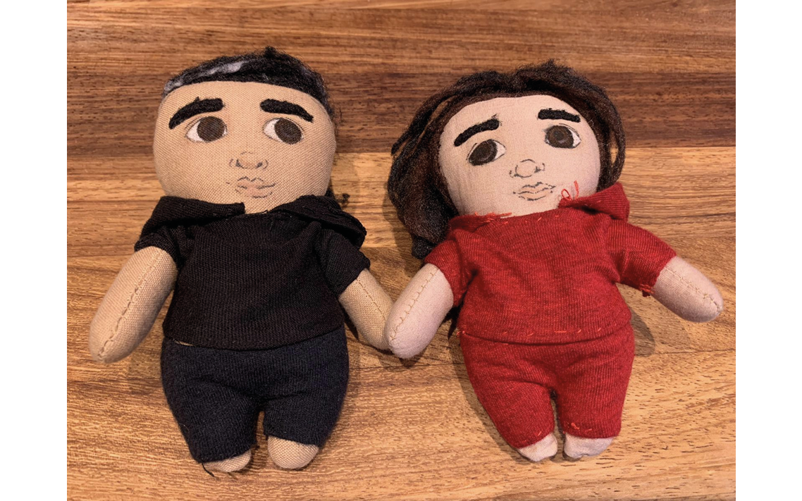 Hand-made fabric mini me figures of a parent and child, with handfelted clothes
