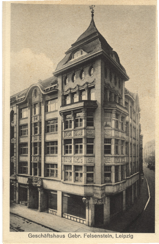 A sepia-toned postcard of the commercial building of the Felsenstein Brothers in Leipzig - the building has a clock tower on the top and is situated on the corner of a street