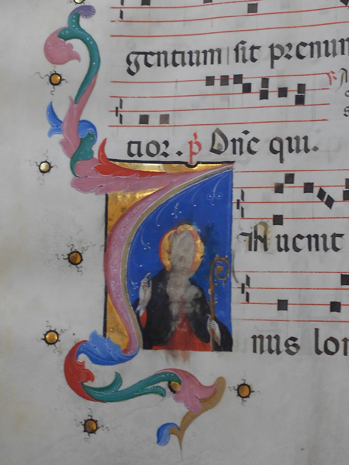 Detail of the previous image, showing the initial with St Augustine, which has been touched and rubbed with a wet finger.