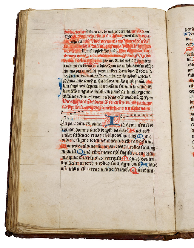 Left half of an opening, with a rubricated noted ritual made in England in the fifteenth century. It contains instructions for performing last rites. Holy water that has splashed on the book has caused the red ink to run.
