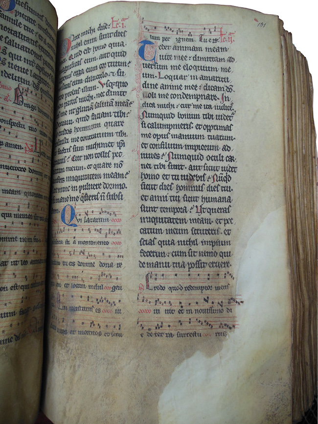 Right half of an opening of the Grand Obituary of Notre-Dame showing a noted Mass for the dead, where the bottom third of the page is browned and degraded, and the corners have been repaired.