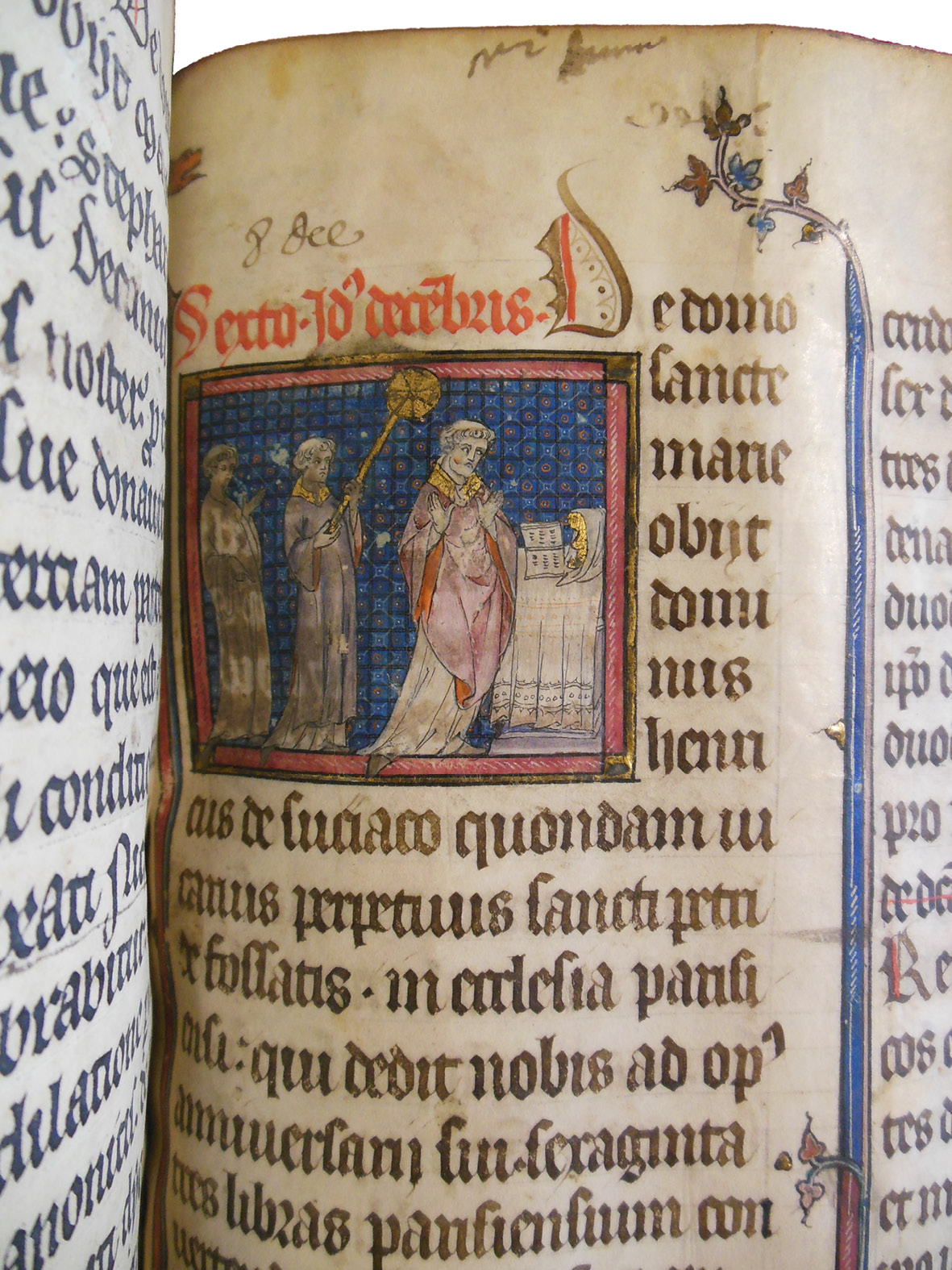 Detail from the the Grand Obituary of Notre-Dame, showing Mass being celebrated for Lord Henry de Sucy, who died on December 8, 1310. The miniature shows a priest performing with a book at an altar, with two acolytes behind him. The image has been touched several times.