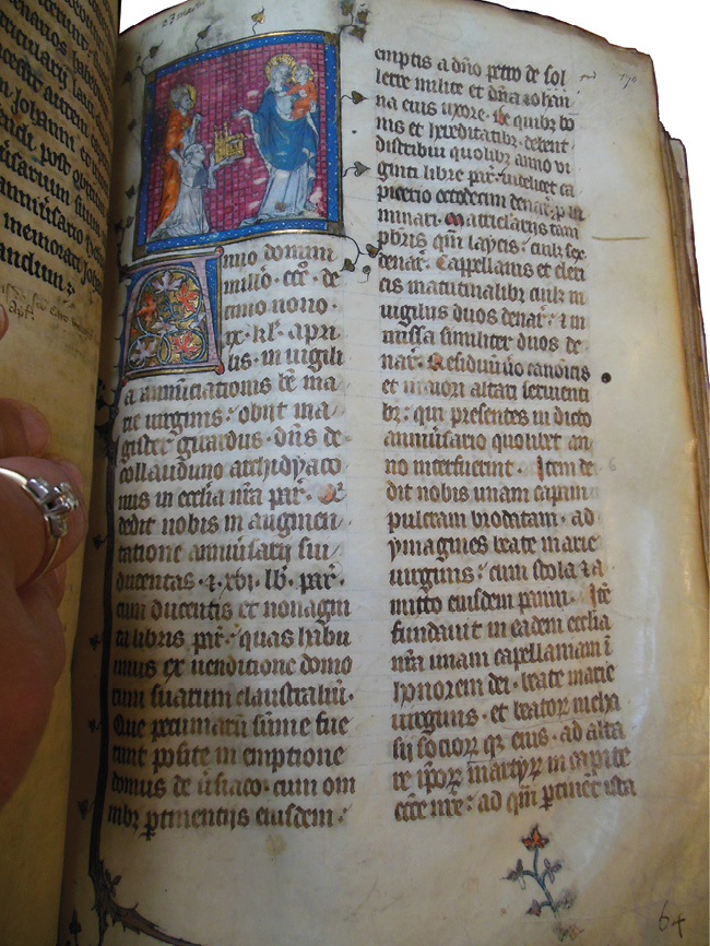 Right side of an opening in the Grand Obituary of Notre-Dame, showing Girardus (or Gérard) de Courlandon before the Virgin and Child. He died on March 23, 1319. The miniature shows a Girardus offering a golden gift to the Virgin Mary. The area around Mary has been touched several times, causing some of the paint to liquefy and stick to the other side of the opening.