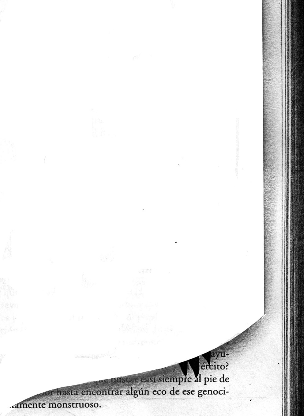 View of a cut book page revealing the Spanish text printed on the page of another book beneath it.