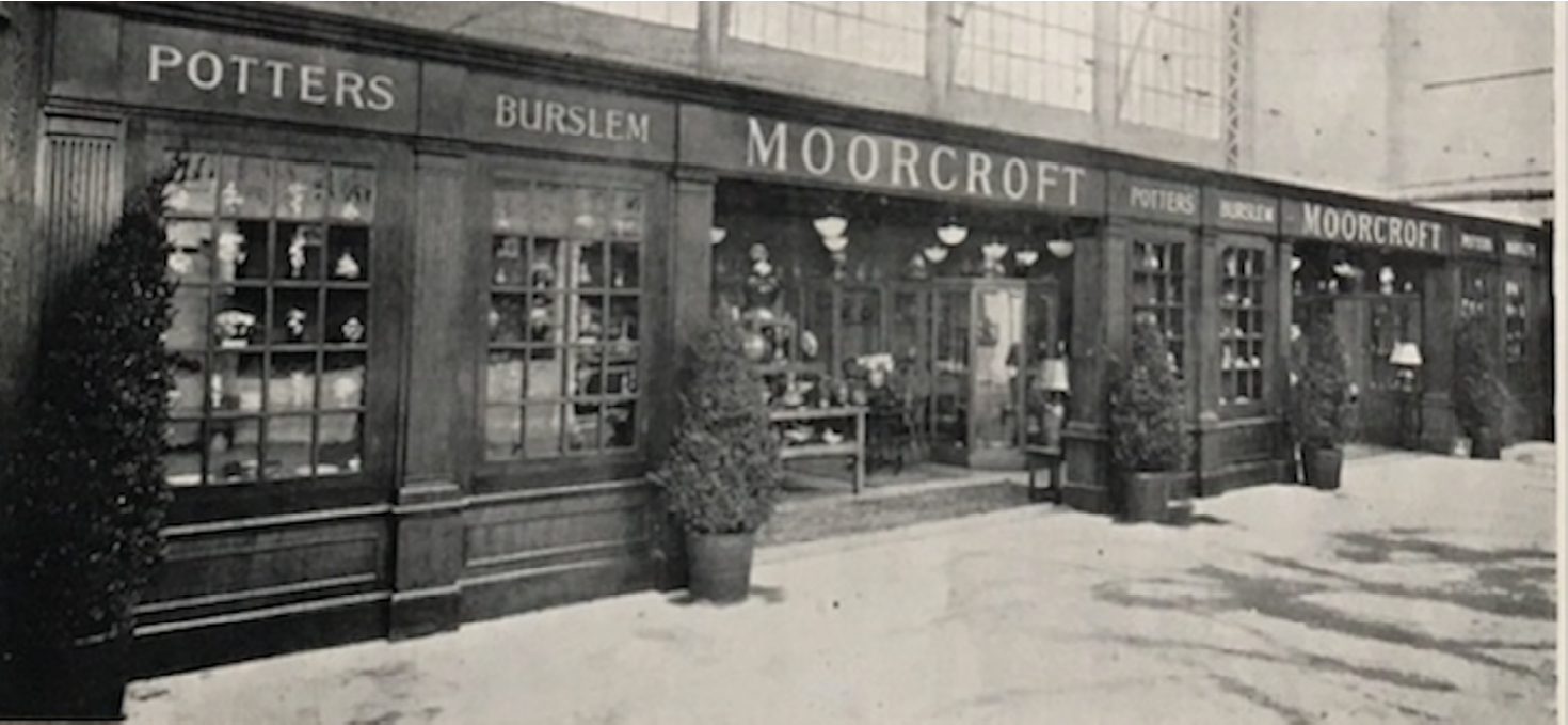 A long frontage with two wide entrances each flanked by double windows.   Over the entrances, the name Moorcroft, with Potters Burslem to either side.   Looking inside, the impression is of plentiful stock in a spacious setting.   ",,,