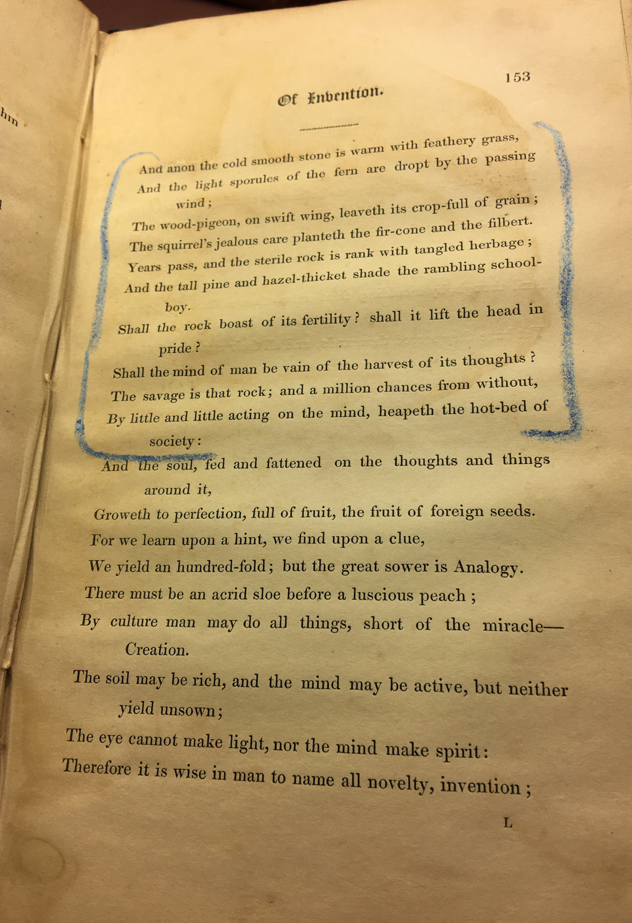 An old printed book with mottled pages held open on page 153. Each sentence on this page is printed on a new line, and a number of lines on the first half of the page are enclosed in two large square brackets marked in blue pencil.