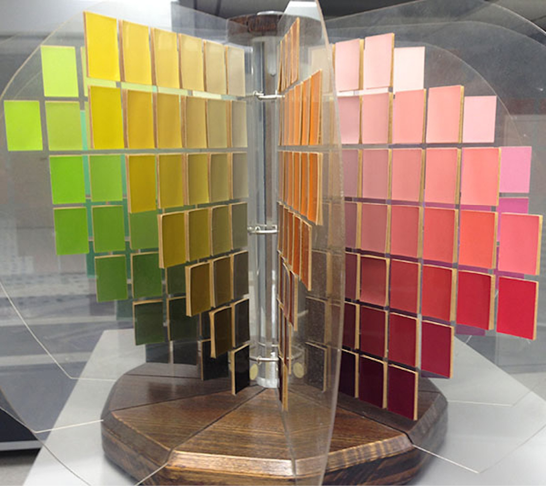 Image of a Munsell color tree displaying an array of color samples arranged in a circular structure, representing hues, values, and chroma.”,