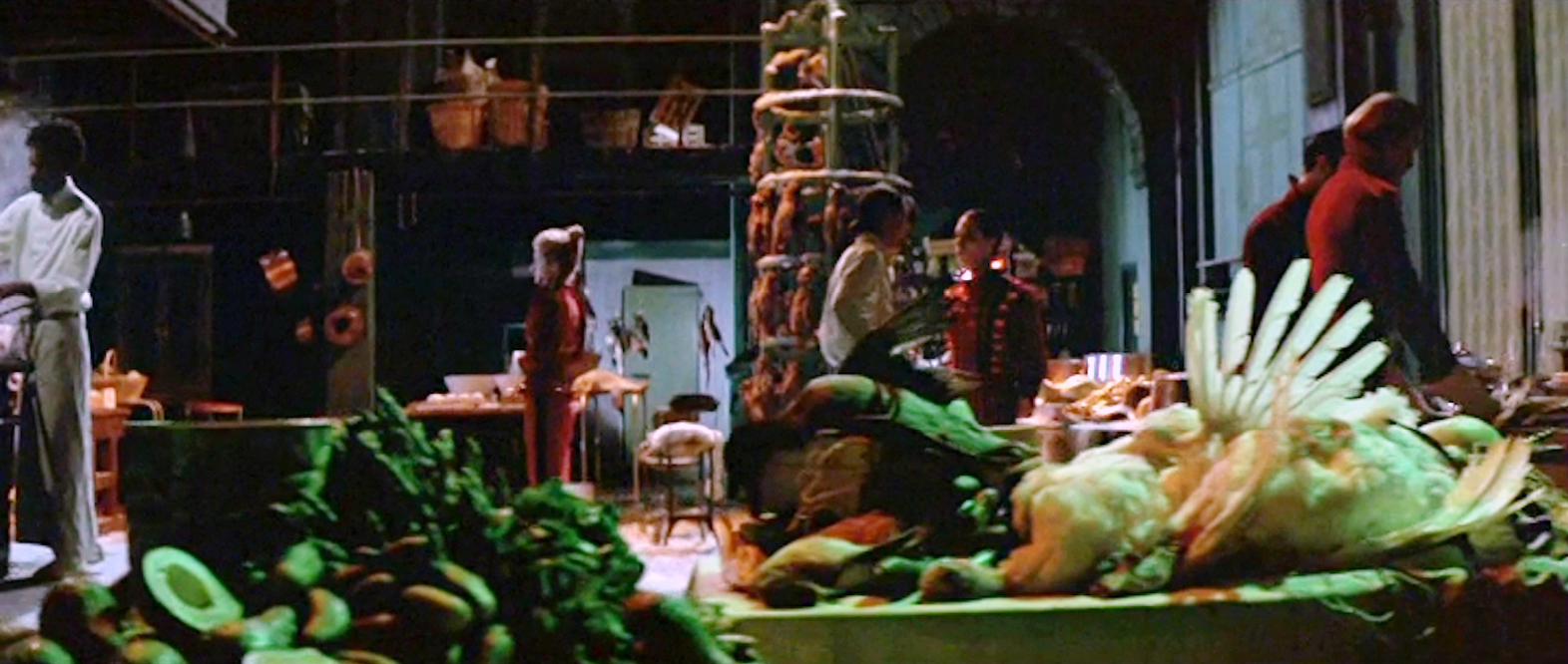 A chaotic kitchen scene from Peter Greenaway’s 1989 film ‘The Cook, the Thief, His Wife & Her Lover’, showcasing an extravagant and grim array of food and kitchen preparations in a dark, theatrical setting.”,