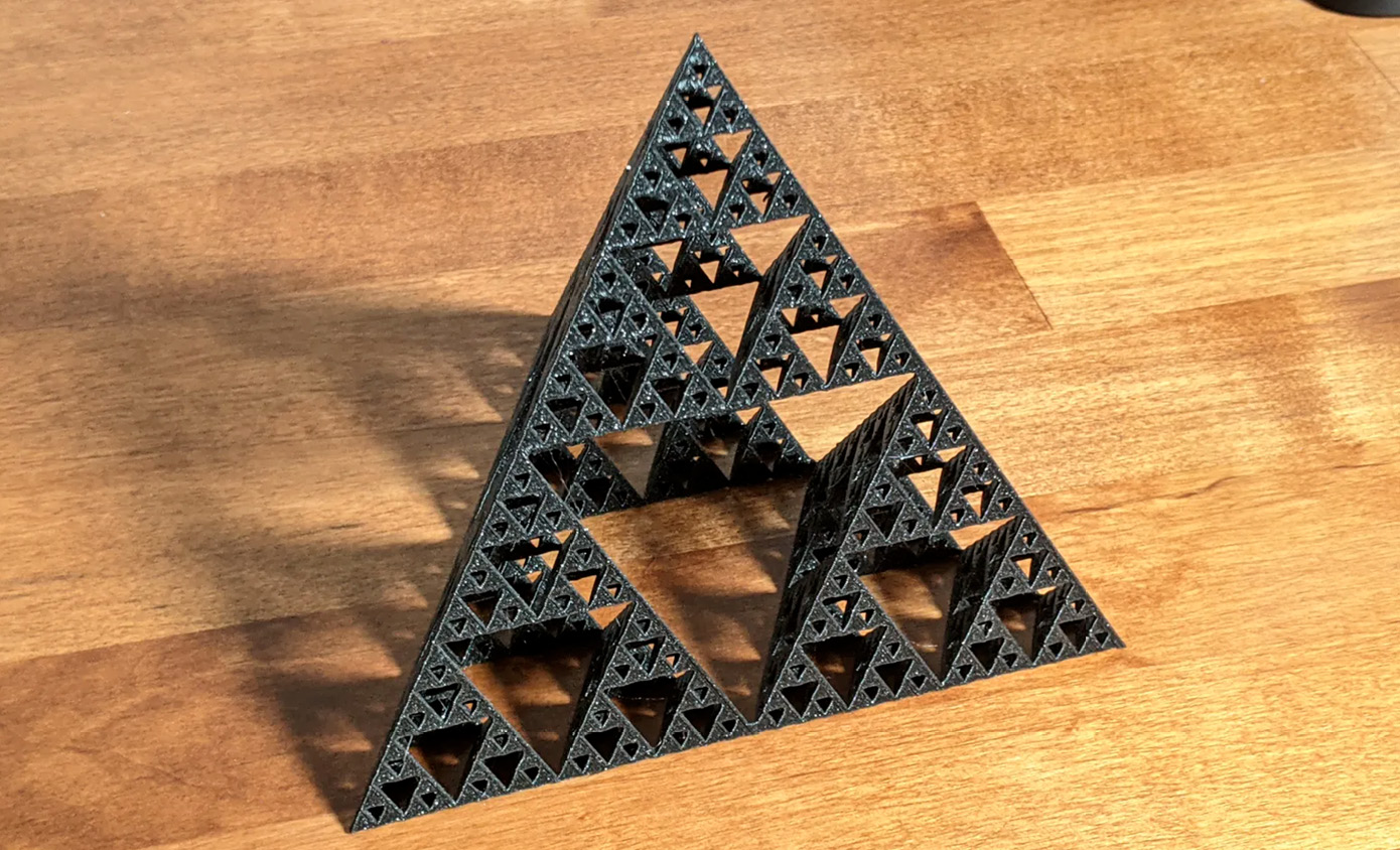A fractal three-dimensional printed model the Sierpiński tetrahedron–tetrahedron enfolded within tetrahedron. The form resembles a triangular-base pyramid and is constructed entirely of triangular shapes.