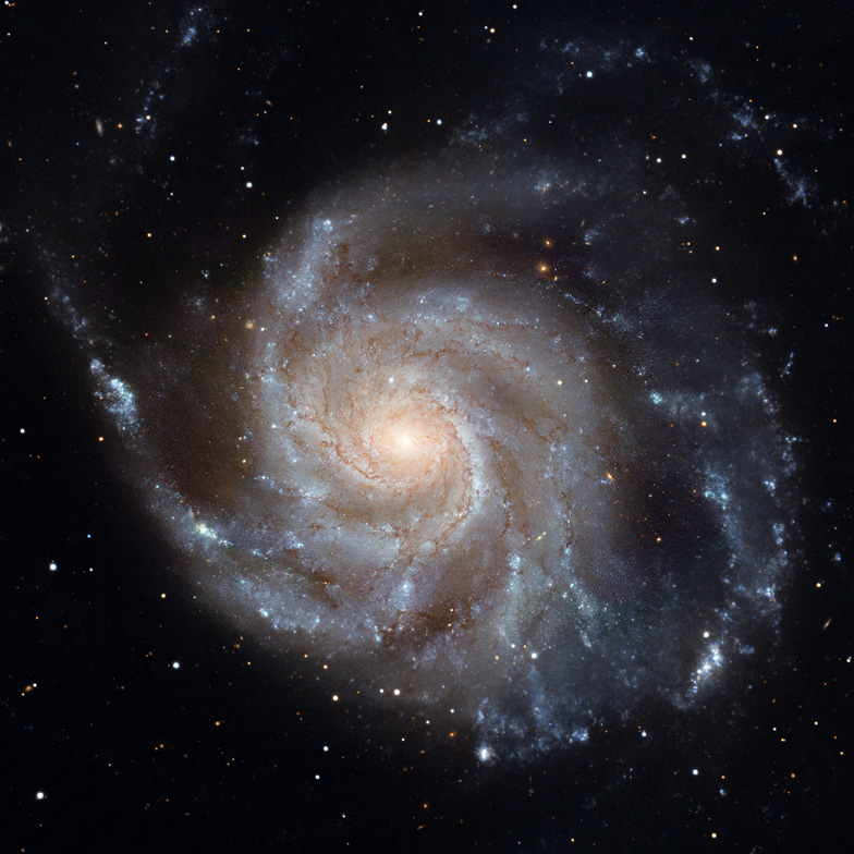 A photograph of a large spiral galaxy with a bright centre and four arms.
