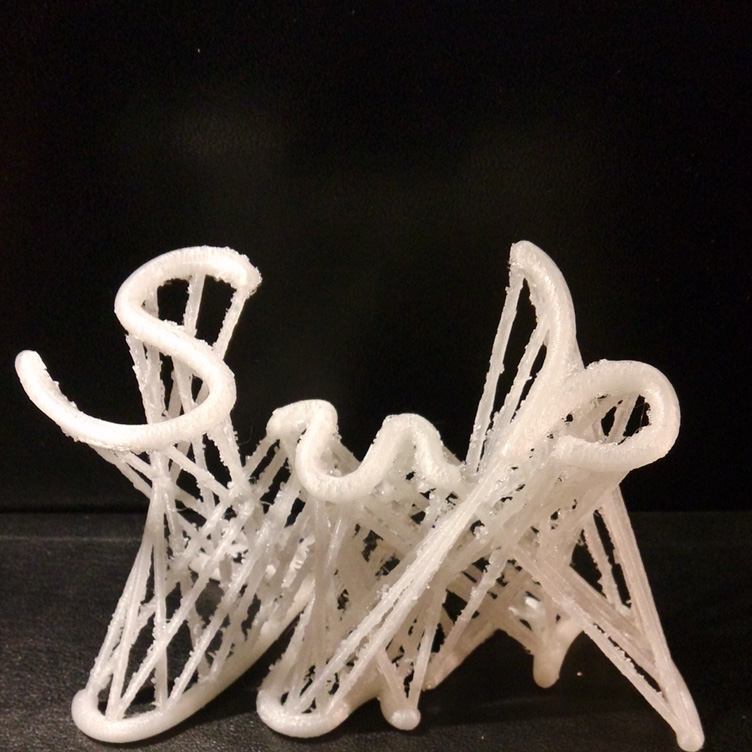 A white, abstract 3D-printed sculpture with intricate, twisted, and interwoven structures resembling a complex latticework, set against a solid black background. The design features a variety of loops, curves, and lines, creating a visually intricate pattern.