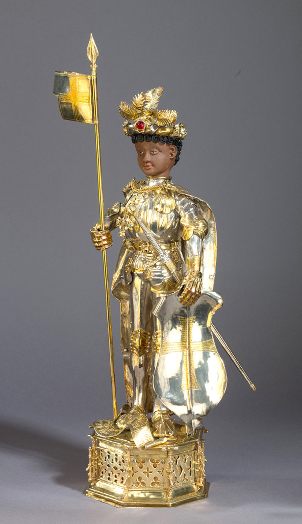The statuette of St Maurice, the patron saint of Kloster Medingen, shows him as black knight with curly black hair, clad in elaborate, stylish armour and holding a spear with a banner in his right hand and a shield in his left. He wears an ornate headdress with semi-precious stones. For a full description see Chapter III.3, under ‘The Black Knight Maurice Intervenes’.