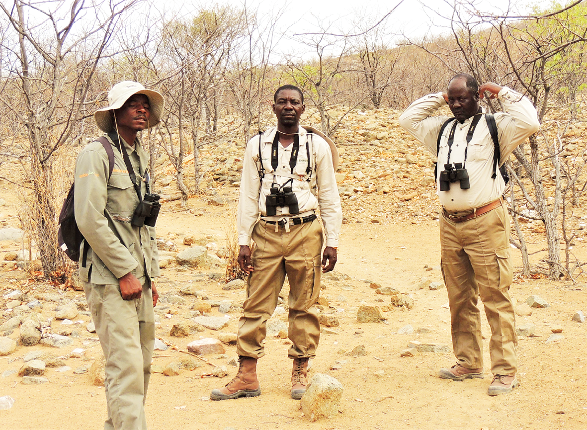 Photograph of three Lion Rangers on patrol in north-west Namibia.