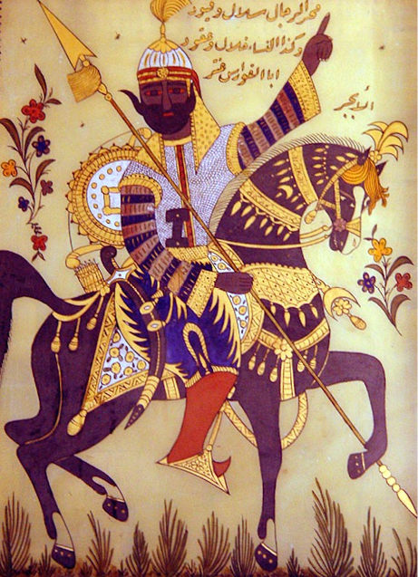 A traditional Middle Eastern illustration of a warrior riding a decorated black horse. The warrior wears ornate golden armour, a white turban, and holds a long spear. Arabic calligraphy is inscribed above him, adding to the historical and cultural depth of the image.